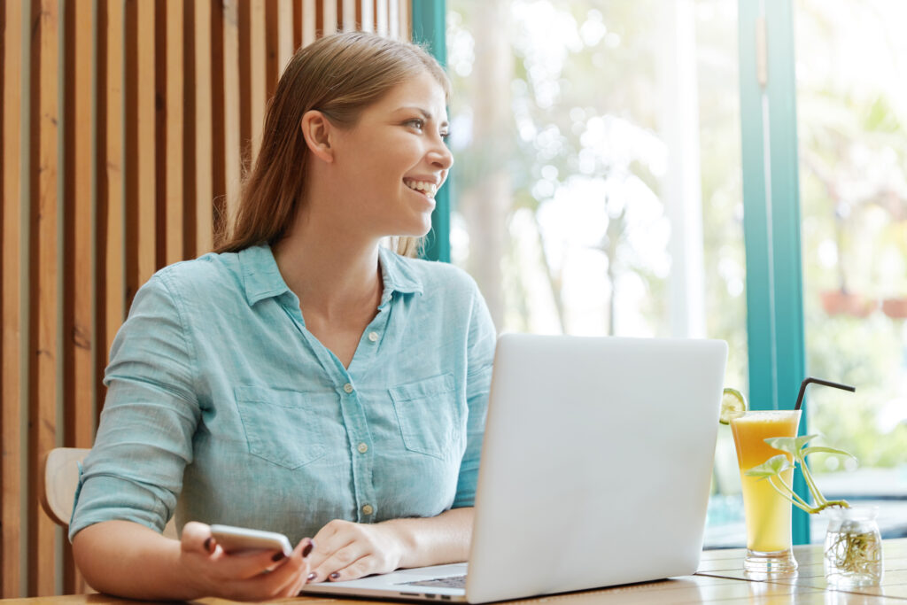 Woman with laptop at cafe